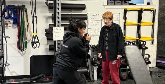 Reimagym coach creating a personalized training plan with a gym member