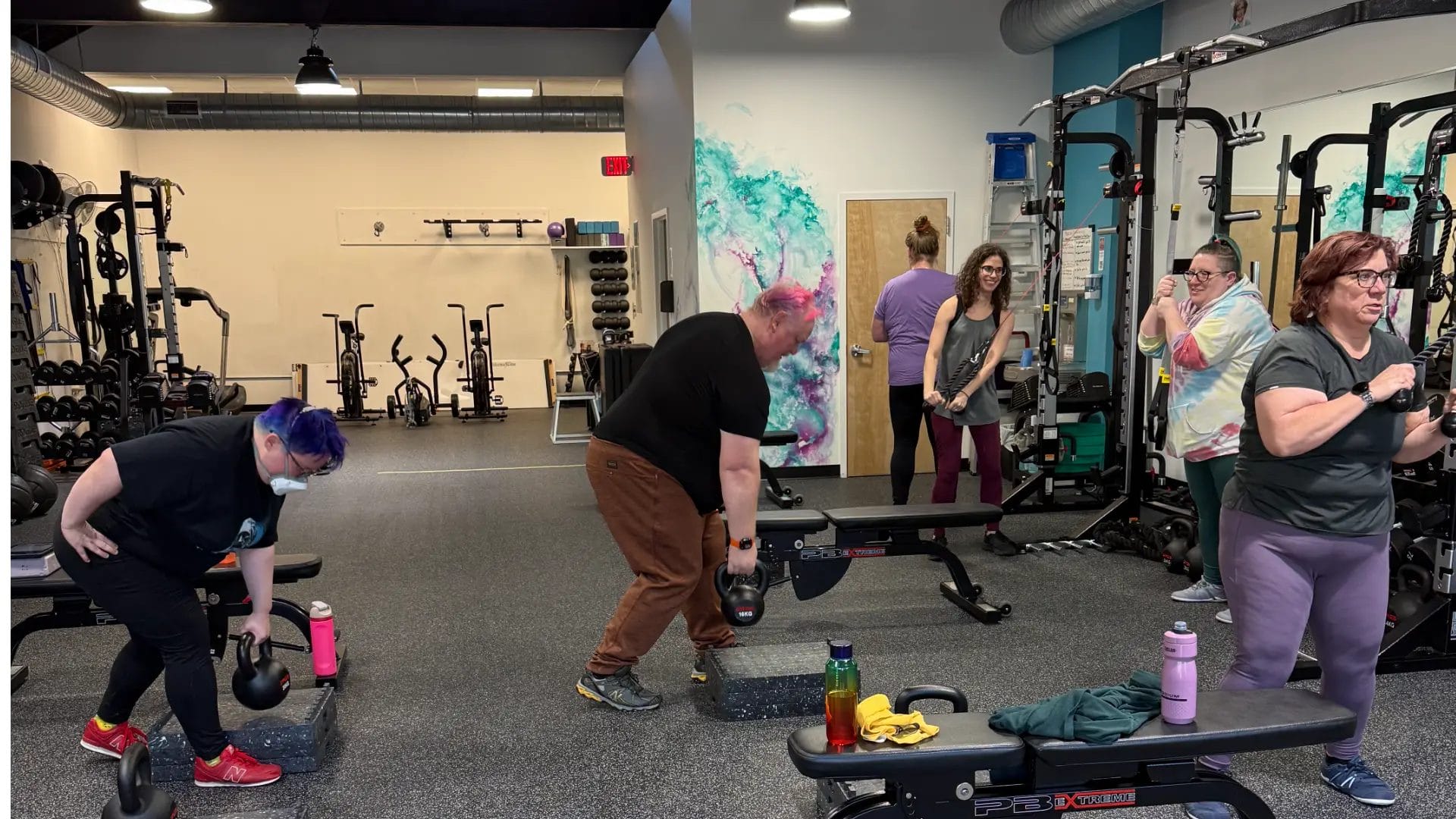 Reimagym gym interior with members training and coaches leading sessions