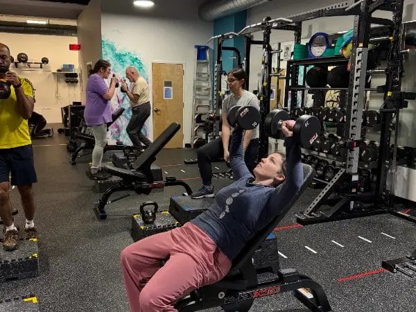 Members participating in Reimagym small group training session in gym