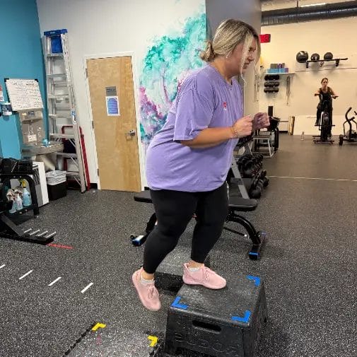 Reimagym member performing strength training exercises with coach supervision